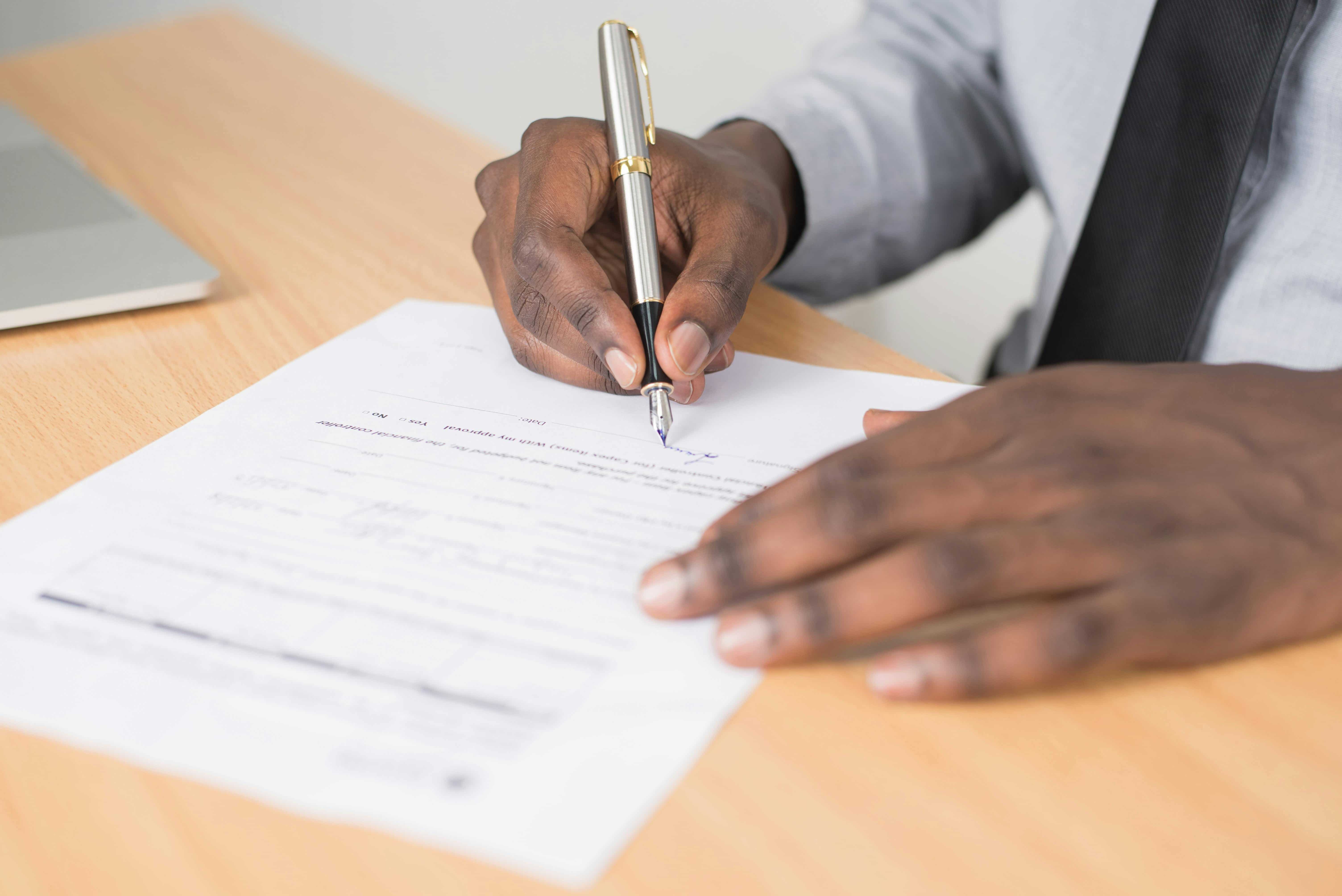 image of person filling out a form